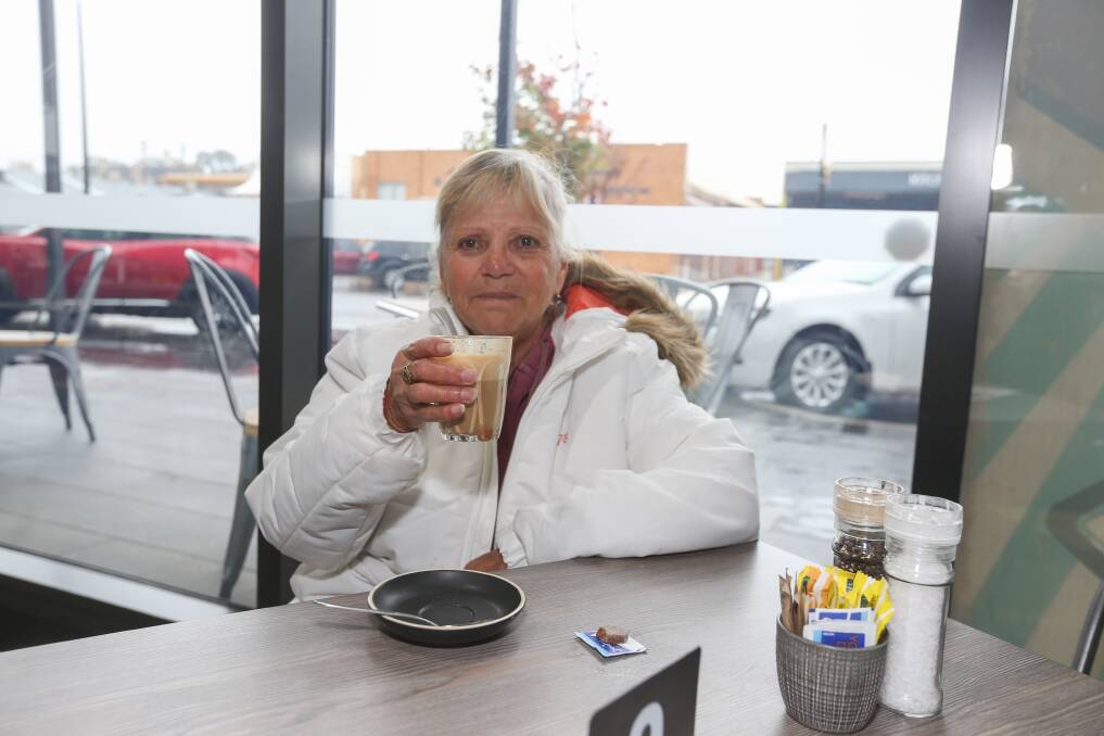 CAFE CULTURE: Wodonga's Margie Smith enjoys a dine-in latte at Blind Freddy's Cafe yesterday. Picture: TARA TREWHELLA