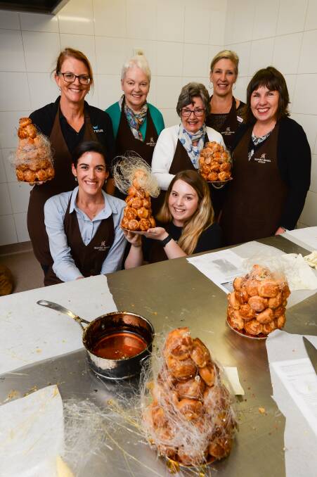 TASTY TREATS: Raquel Ortega and Brianna Carracher (front), Jenny Butterfield, Kaye Deanshaw, Val Orme, Janelle Parker and Trish Pearce display some results of their labour. Picture: MARK JESSER
