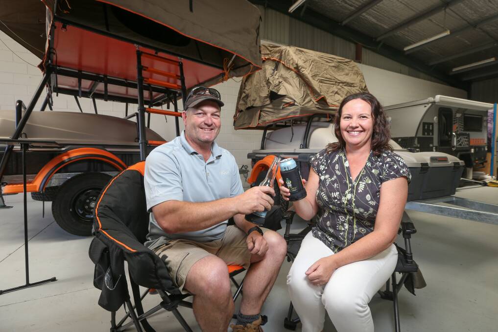 CHEERS: Scott and Linda Fraser, of Camper Trailers Albury Wodonga Sales and Hire, toast better days ahead as business picks up in the fortnight since the NSW-Victoria border reopened. Picture: JAMES WILTSHIRE