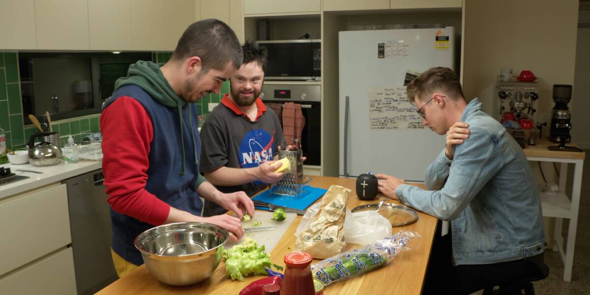HELPING OUT: Duncan, Ned and Nic in the kitchen of their shared home in a regional town. Their situation is one of several types of Individualised Living Options for people with disabilities, the topic of a webinar on Monday.