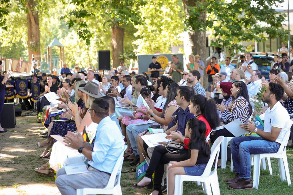 The audience applauds during the citizenship ceremony at Albury Council's 2023 Australia Day celebrations at Noreuil Park. Picture by James Wiltshire