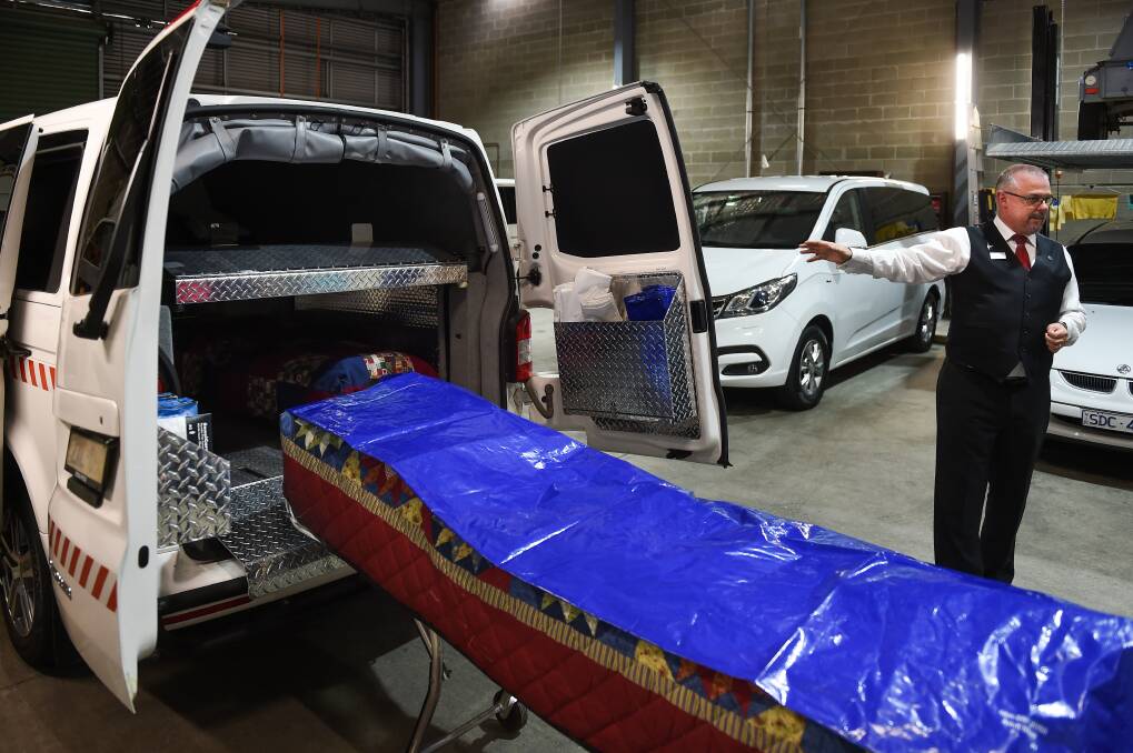 SPECIALIST SKILLS: John Hossack Funeral Services manager Brett Williams explains the fit-out of the coroner's van. Picture: MARK JESSER