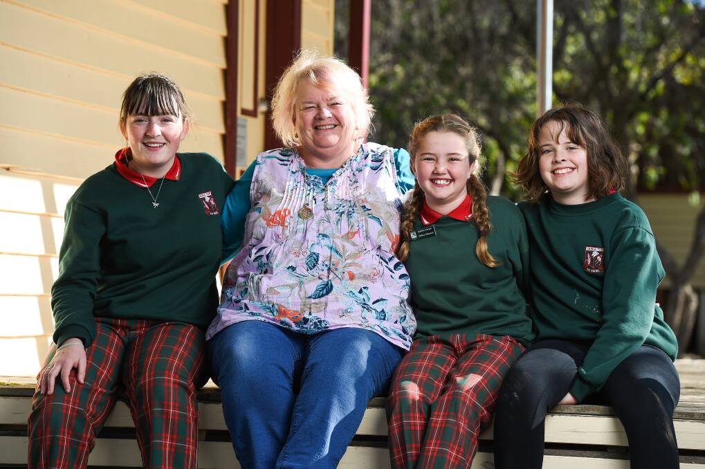 TIME TO BID FAREWELL: Retiring teacher Elaine Kirk with Table Top Public School year 6 students Zoe Reichel, 12, Anthea Johnston, 11, and Mia McEachern, 11. She always joked she would retire when they were finishing primary school. Picture: MARK JESSER