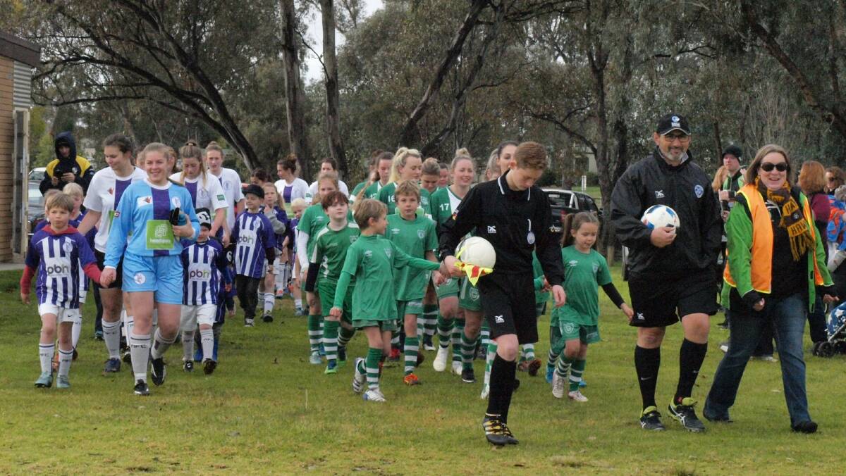 Players and supporters of the Melrose and Albury United clubs join together to raise awareness of mental health issues during their Albury-Wodonga Football Association encounter on Sunday.
