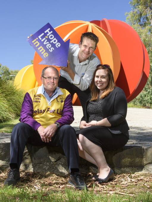 POINT TO THE FUTURE: Border Relay For Life outgoing chairman Carl Friedlieb (centre) hands the role over to Peter Whitmarsh and Kate Wilkinson. Picture: SIMON BAYLISS