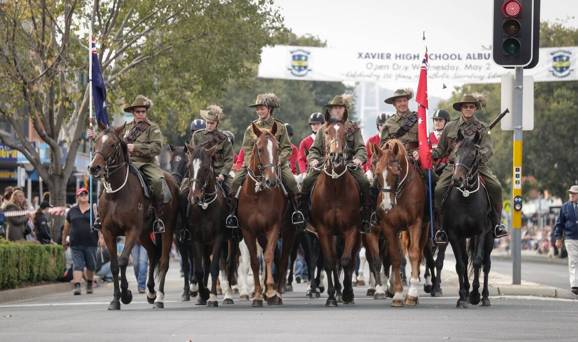 WE WILL REMEMBER THEM: Horses and riders lead off last year's Anzac Day march along Dean Street, Albury. Veterans of recent conflicts are encouraged to become more involved in this significant date on the calendar.