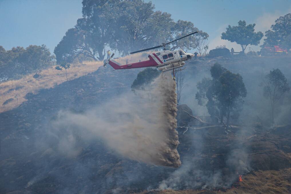 Firefighters attack Tuesday's grass fire. Pictures: JAMES WILTSHIRE