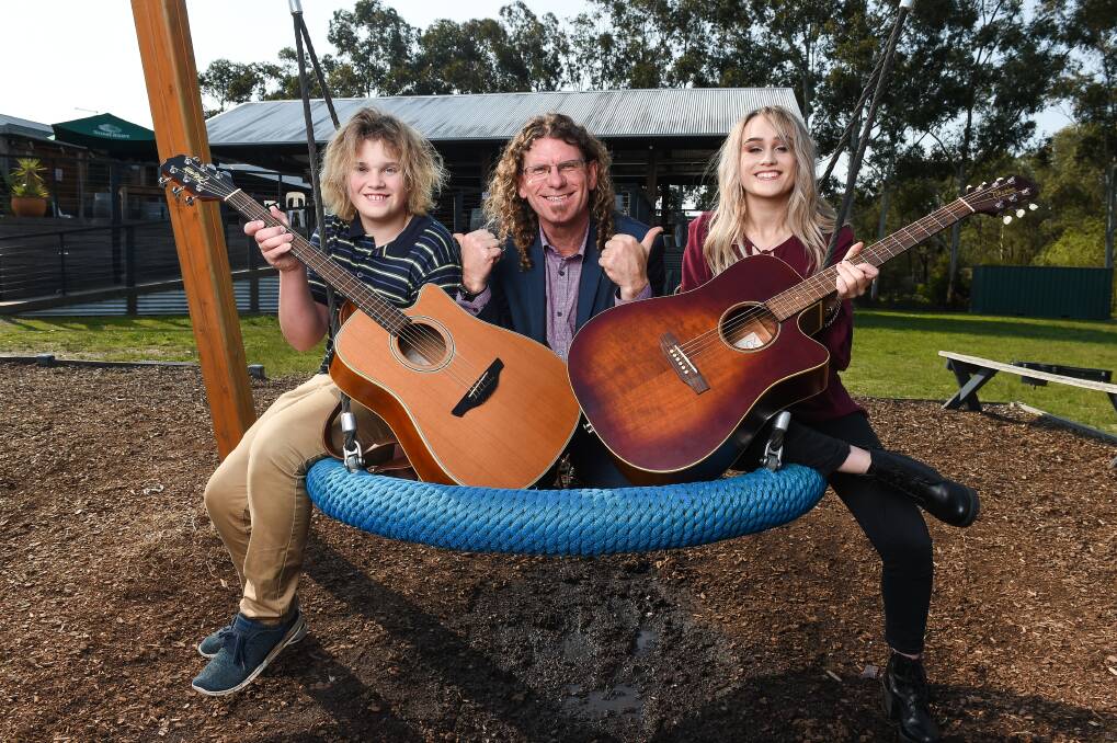 SUNSHINE WEEK: Zac Spalding, 13, and his sister Eliza, 16, hang out with compere Steve Bowen ahead of Sunday's cancer centre fundraiser. Picture: MARK JESSER