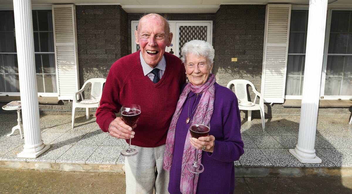 HERE'S TO US: Ian and Roma Richards outside their Wodonga home of many years. Mr and Mrs Richards, aged 95 and 94 respectively, met at a North Albury dance and married on Saturday, August 6, 1949. Picture: MARK JESSER