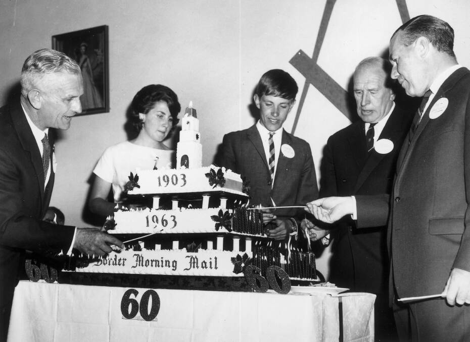 Lighting the candles on the Mails 60th anniversary cake in 1963 took some time for Gordon Dowling, Libby Mott, David Mott, Cleaver Bunton and Pat Brennan.