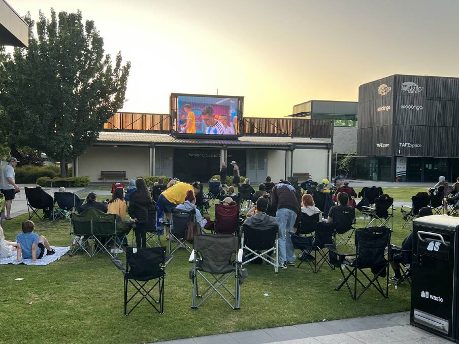 Fans gather in The Cube Wodonga courtyard last year to watch the Socceroos' World Cup round of 16 clash against Argentina.