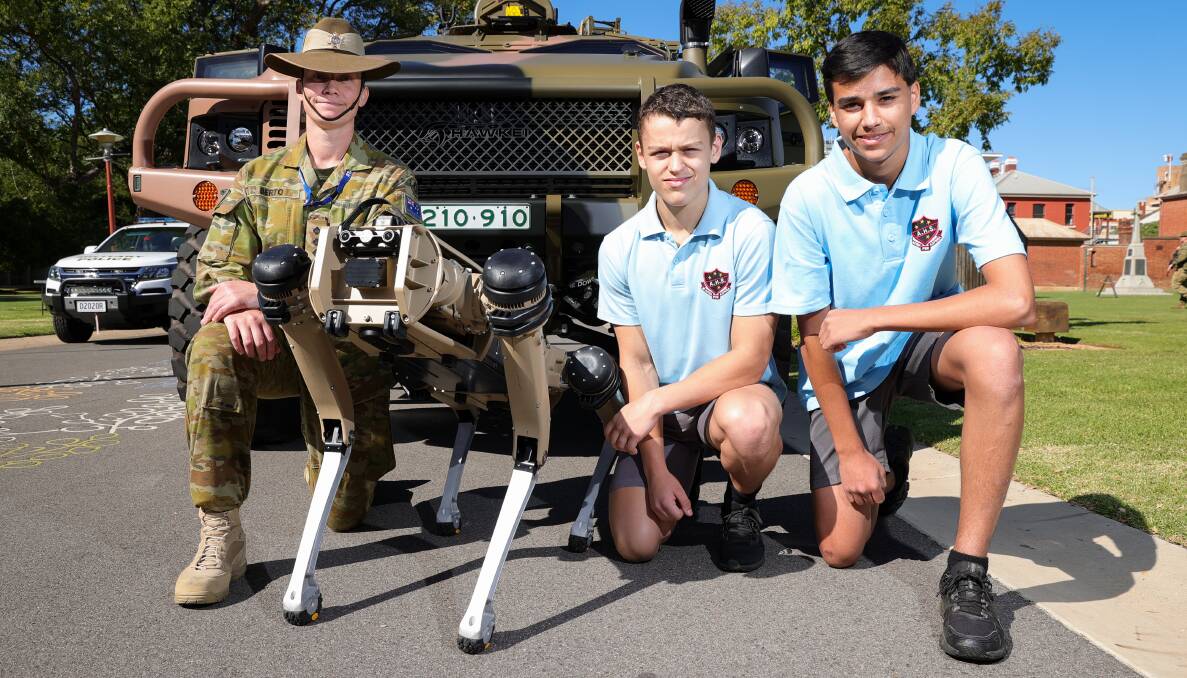 ARMY EQUIPMENT: Captain Gemma Berto shows Albury High School students Jake Cruise and Jay Lingham, both 16, a robotic dog, which can be used in high-risk settings to reduce the personal danger. Picture: JAMES WILTSHIRE