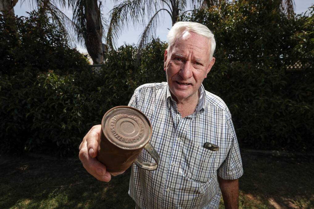 FAMILY HISTORY: Glenroy's David Murray holds the mug his father Bill made out of a milk can discarded from the Uiver, which dam workers helped pull out of the Albury racecourse mud 84 years ago. Picture: JAMES WILTSHIRE