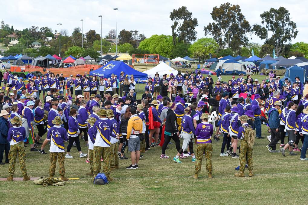 STRONGER TOGETHER: The crowd claps as the survivors and carers walk the first lap of the 2019 Border Relay For Life at Alexandra Park. Picture: MARK JESSER