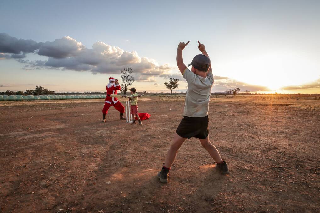 HOW'S THAT: Border Mail photographer James Wiltshire captures Christmas in rural Australia with his award-winning photo, helped by Brett Lieschke and Cooper McMaster, 6, and, of course, Santa.