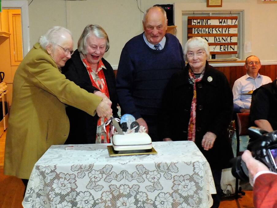 ANNIVERSARY: Father Laurie Allott's widow Heather joins Bev Butler, Donald Peters and Florence Thompson in cutting the Anglican Old Time Dance's 40th birthday cake.