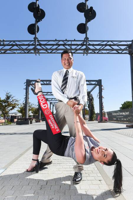 HANGING AROUND: Dance teacher Johnny Phung helps real estate sales agent Deb Woodall kick up her heels for Stars of the Border Dance for Cancer. Picture: MARK JESSER