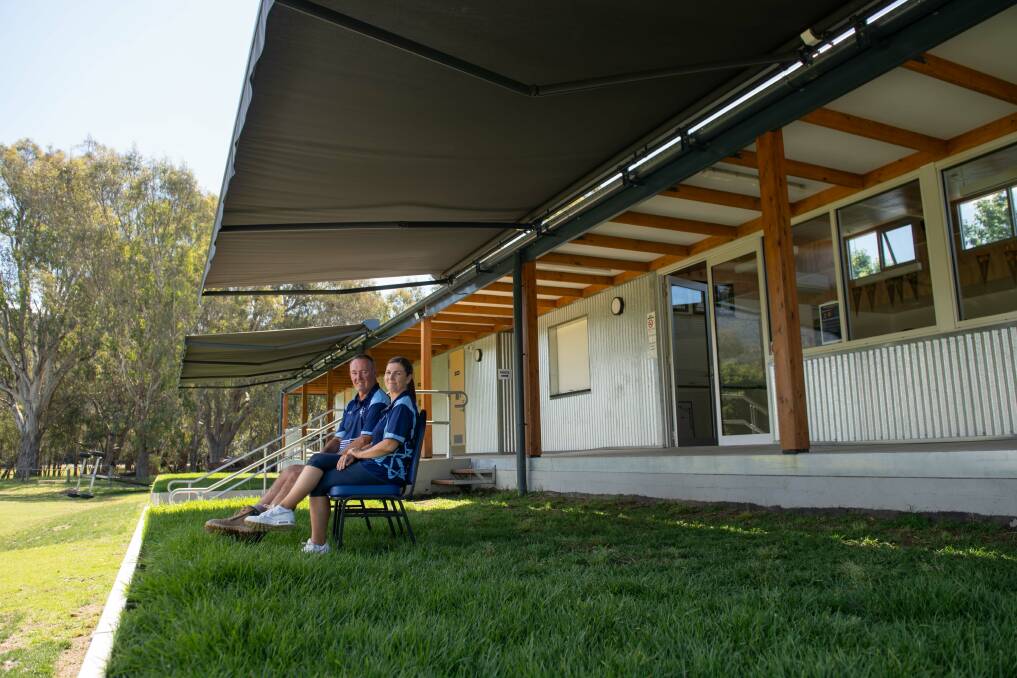 Kiewa Cricket Cub's recent upgrade includes motorised retractable awnings that, as director of facilities Stuart Lancaster and chairperson Annie Heffernan demonstrate, create more shade for spectators. Picture by Tara Trewhella 
