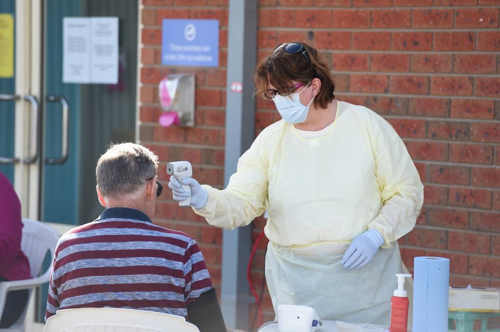 KEEPING VIGILANT: Temperatures are checked at a Murrumbidgee Local Health District mobile COVID-19 testing clinic at Henty last month. Picture: MARK JESSER
