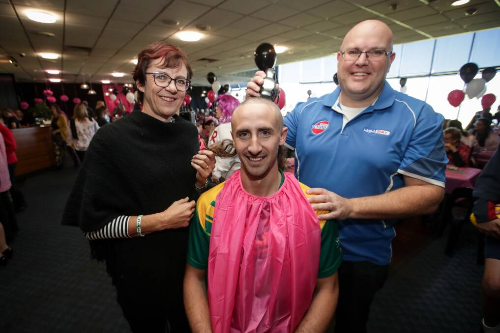 HAPPY TO HELP: Michelle Hensel, an original Brave Heart, and sporting identity Heath Naughton take charge of proceedings as Josh Lloyd loses his locks for a good cause. Picture: JAMES WILTSHIRE
