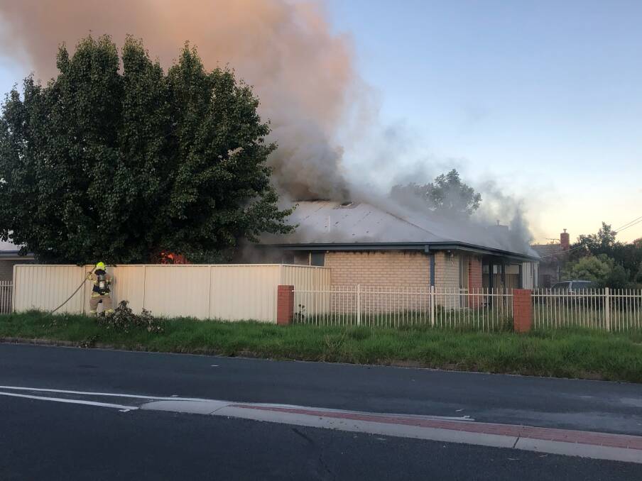 SMOKE VISIBLE: Fire crews tackle the blaze at the Wodonga unit on Monday evening. Picture: SUPPLIED