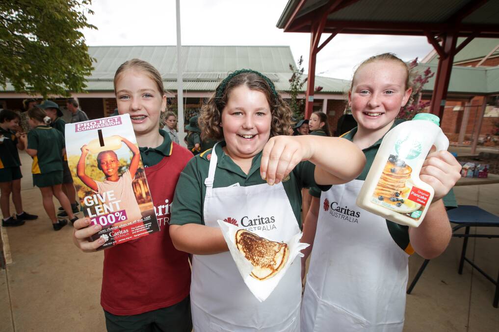 FULL TOSS: St Mary's Primary School year 6 students Holly McMahon, Aleisha Price and Georgina Upton, all 11, help raise money for Caritas. Picture: JAMES WILTSHIRE