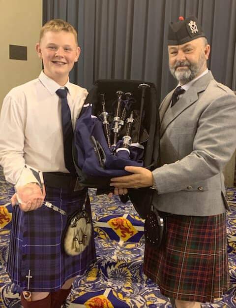 PRESENTATION: Albury student Liam Nicolson receives new bagpipes as part of his C grade success at the national titles held at Scotch College in Adelaide. Picture: FACEBOOK