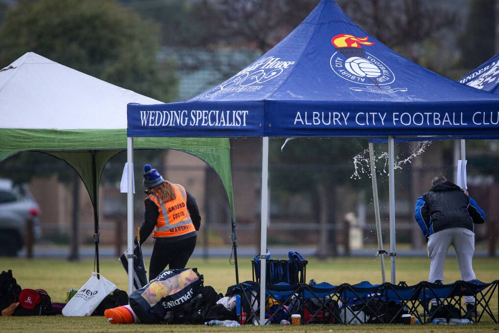 SIGN OF THE TIMES: A COVID marshall oversees the soccer at Lavington's Jelbart Park on Sunday. Picture: JAMES WILTSHIRE