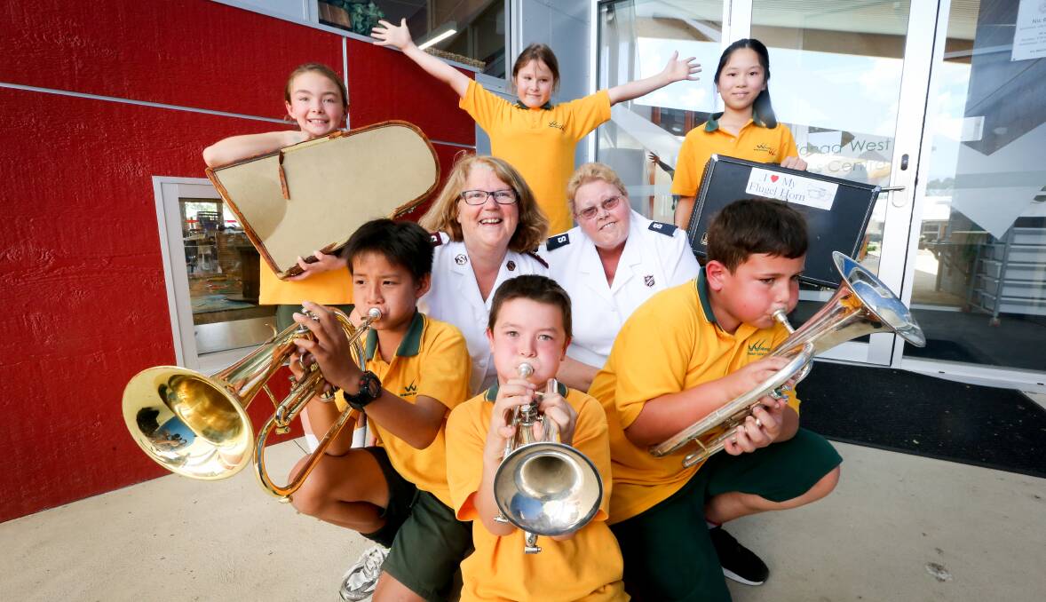 JUST BRASS: Keen to get started are Wodonga West students Haley Waite, 9 (back left), Sharlee West, 10, Nancy Pham, 11, Senghong Heng, 11 (front left), Jayden Waite, 8, and Kyron Ward, 10 with Captain Christine Abram and Gail Tuddenham of the Salvation Army. Picture: KYLIE ESLER