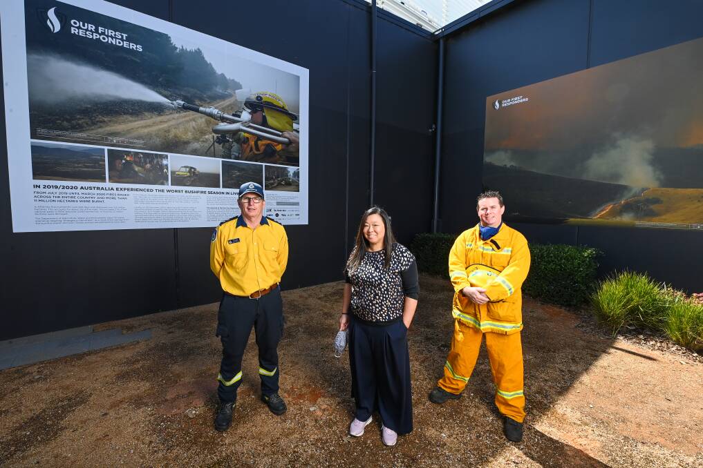 PUBLIC DISPLAY: NSW RFS member Ian Avage, of Splitters Creek, curator Aimee Chan and Wodonga West's Dave Rossiter at the High Street installation. Picture: MARK JESSER