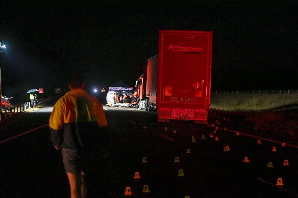 Investigators work into the night after Thursday morning's collision on the Hume Freeway near Chiltern. Picture by Mark Jesser