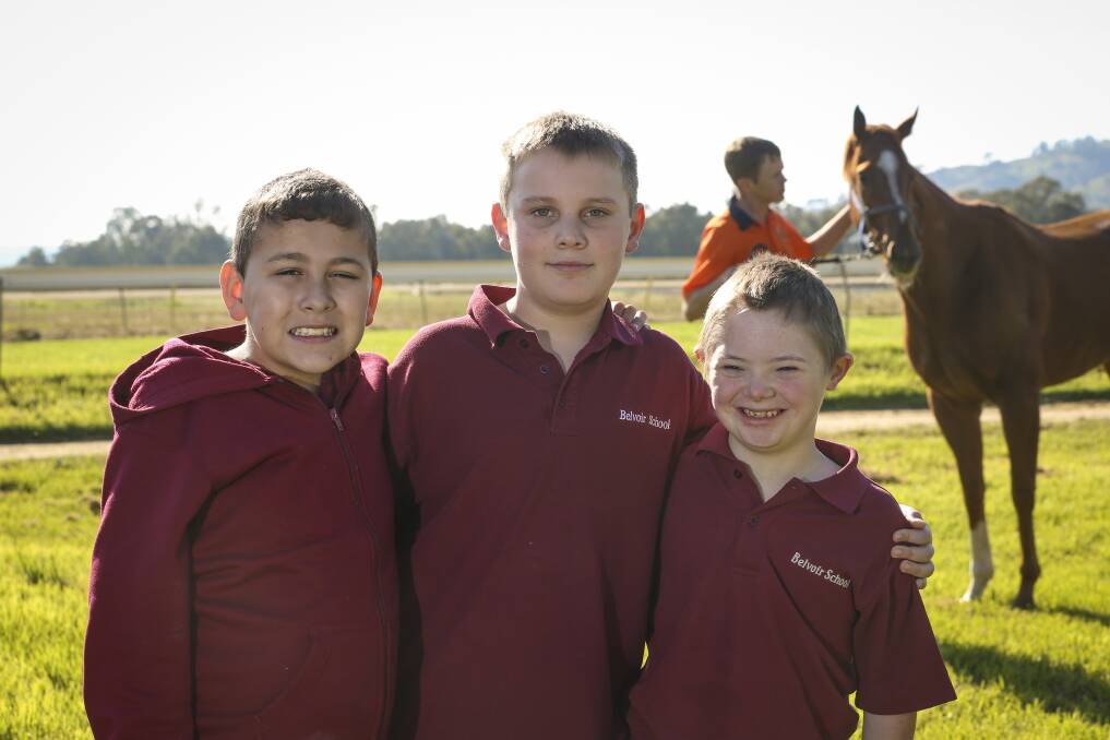 HORSING AROUND: Belvoir Special School students Darcey Simpson, 10, Tyson Cox, 10, and Jack Halley, 12, spend some time with Jack Maher, a former student who now works at Wodonga Racecourse. Picture: JAMES WILTSHIRE