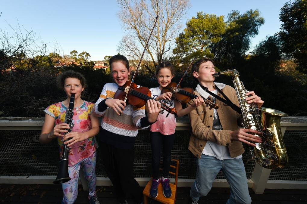 MAKING MUSIC: Annabelle Doherty, 10, joins in as her sisters Grace, 12, and Elise, 7, and cousin Alex Lutton, 13, prepare for next month's Border Music Camp. Picture: MARK JESSER