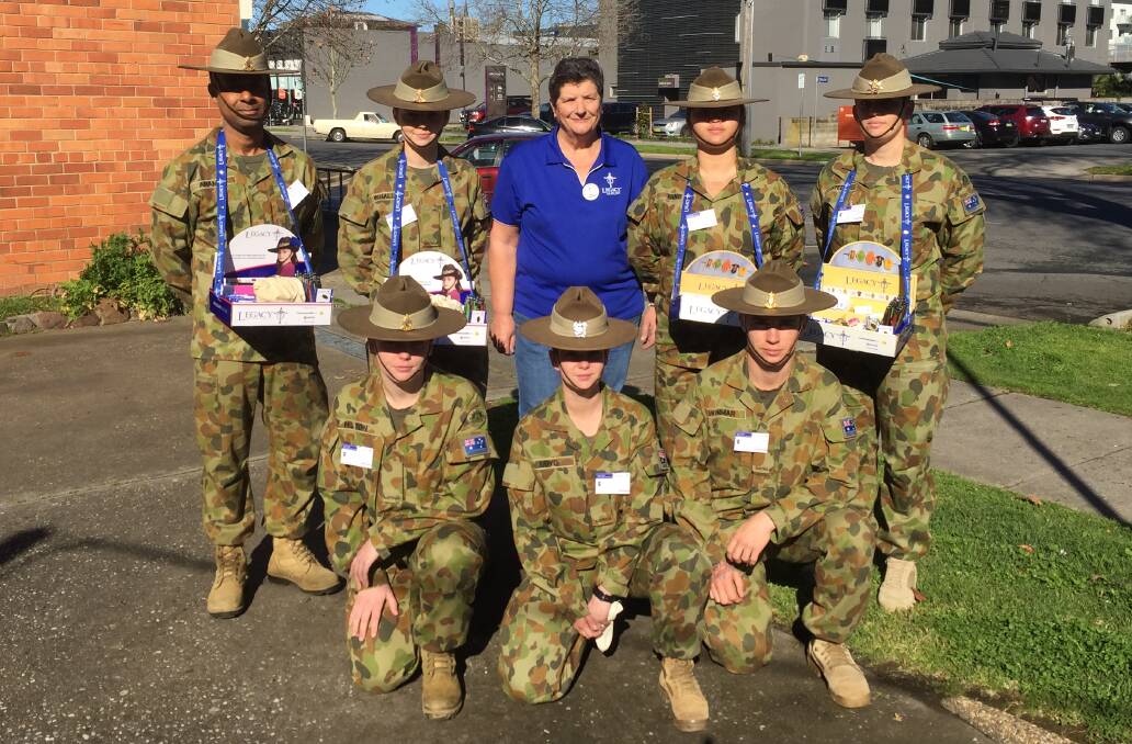 CONSTANT CARE: Legacy Club of Albury appeals chairperson Kay Polsen with Defence personnel from Latchford Barracks, Bonegilla, ahead of Friday's annual collection.