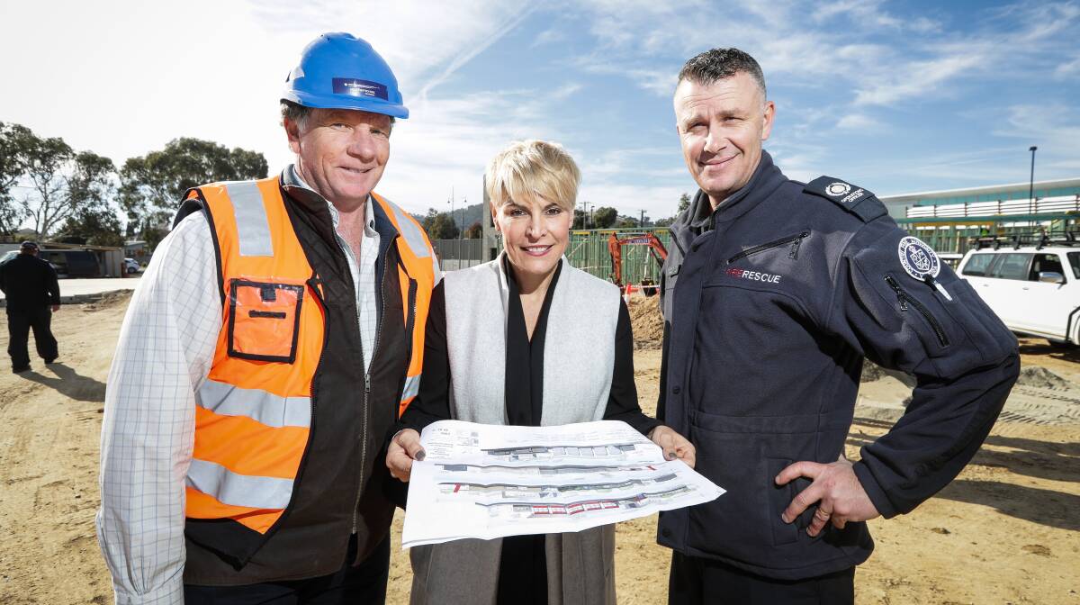 PLANNED PROGRESS: Southern Cross Developers director John Tyrrell, Wodonga mayor Anna Speedie and Wodonga Fire Station officer in charge Ashley Mills look over the ongoing construction. Picture: JAMES WILTSHIRE
