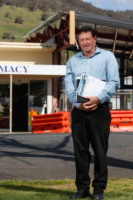 BUILDING A FUTURE: Towong mayor David Wortmann stands in front of the community centre under construction, with a 1950s shopfront next door. Picture: MARK JESSER