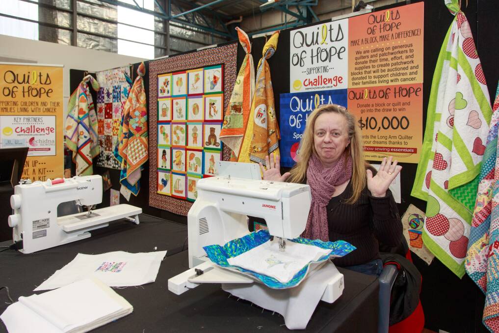 COLOURFUL ARRAY: Liz Ludington sits ready at the machine to help anyone wanting to make a quilt or block for Quilts of Hope. "People are really excited, they can't wait to go home and do it," she says. Picture: SIMON BAYLISS