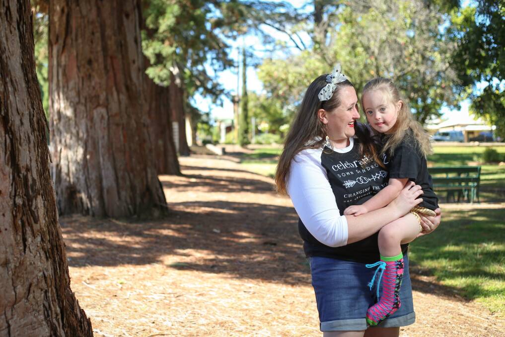 MOTHER AND DAUGHTER: Ellen and Cassie Huggins share a moment in a Beechworth park. Picture: JAMES WILTSHIRE