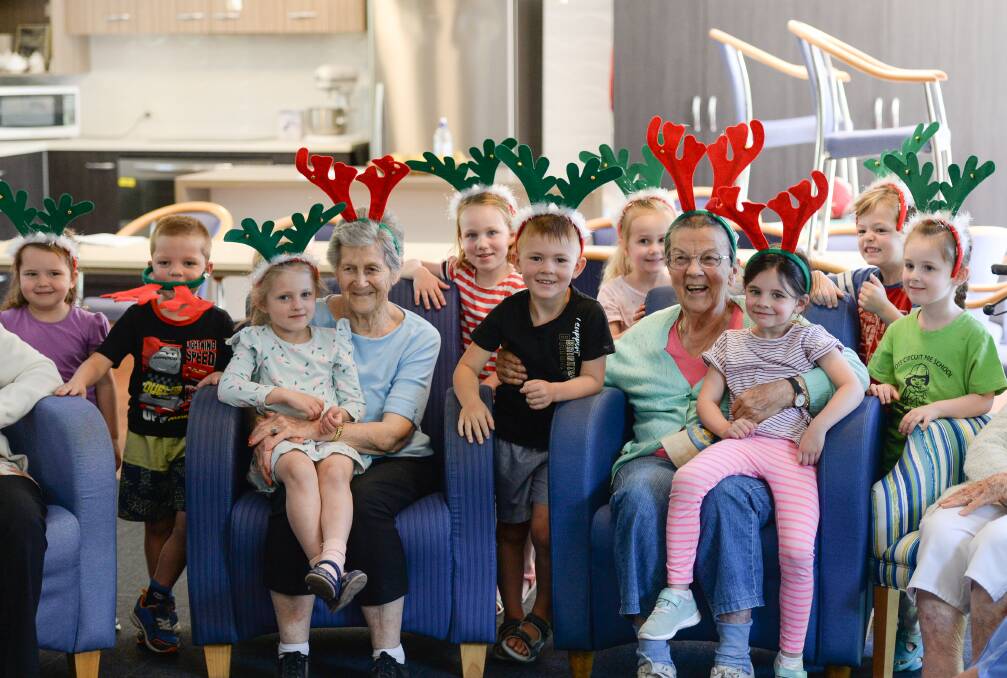 HAPPY TOGETHER: Ross Circuit Preschool children and UPA residents share a festive moment during the youngsters' visit on Wednesday. The fortnightly excursions are an established part of the preschool's program. Picture: MARK JESSER