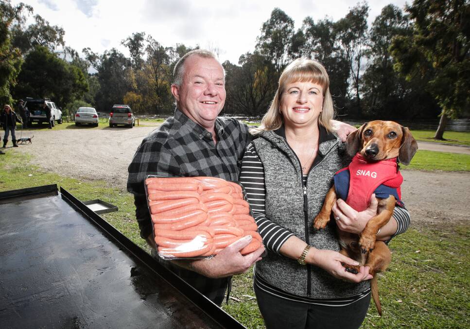 A HAPPY ENDING: Mark and Karen Ellis, of Wodonga, prepare for Saturday's community barbecue, their way to thank all the people, many of them strangers, who helped search for their missing dachshund Snag. Picture: JAMES WILTSHIRE