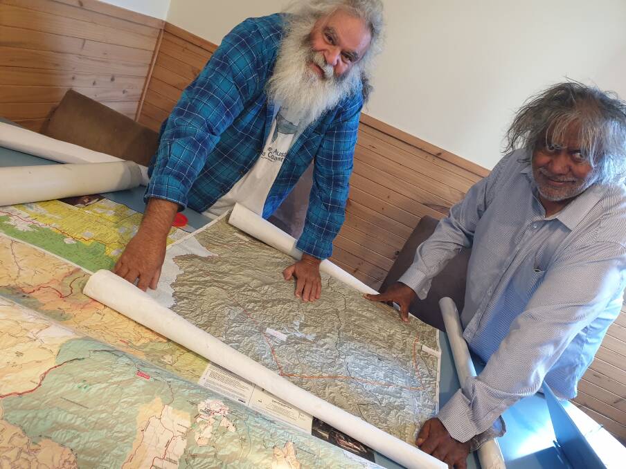 STORIES OF COUNTRY: Senior Jaithmathang elders Roderick McLeod and Goengallajumma Bazil McLeod look over maps of Falls Creek at Howmans Gap Alpine Centre. Camp manager Michael Jowett said it was a privilege to witness.