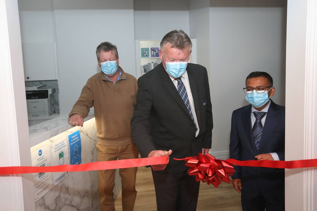 OFFICIAL OPENING: Corowa doctors Michael Love and Ayon Guha watch as Federation mayor Pat Bourke cuts the ribbon at Redgum Skin Clinic on Monday. Picture: JAMES WILTSHIRE