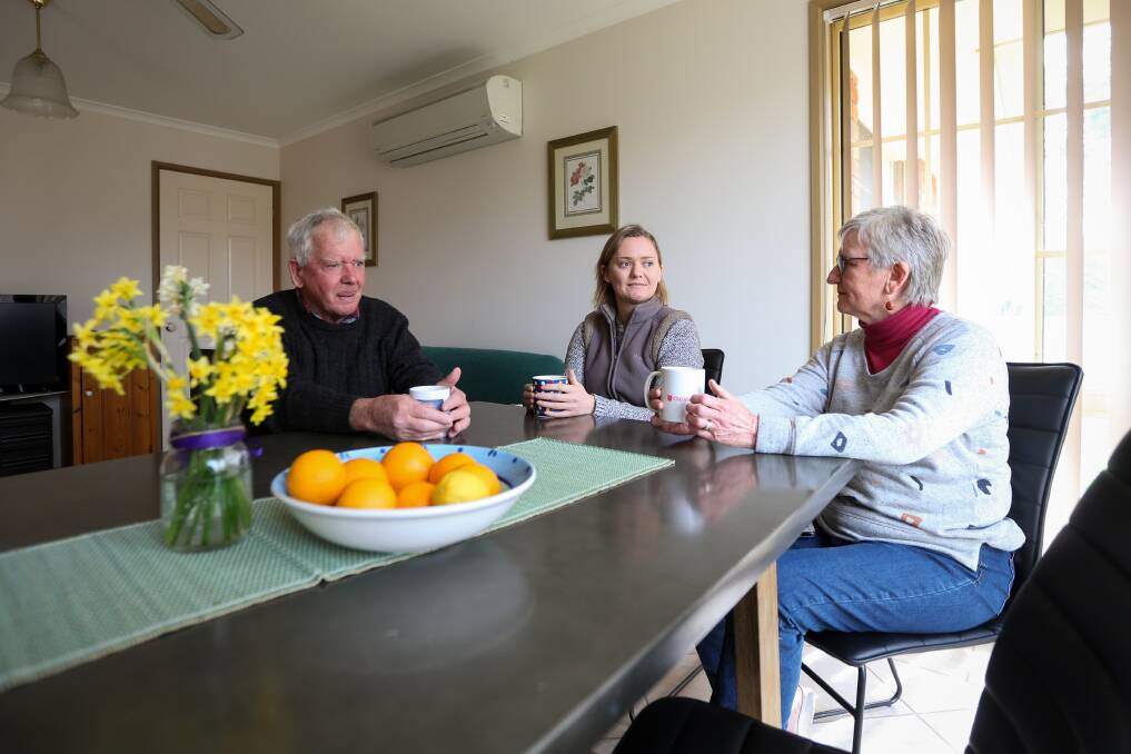 NORMAL DAYS: Peter, Ainslie and Alison Campbell share a cuppa around the dining table. Picture: JAMES WILTSHIRE