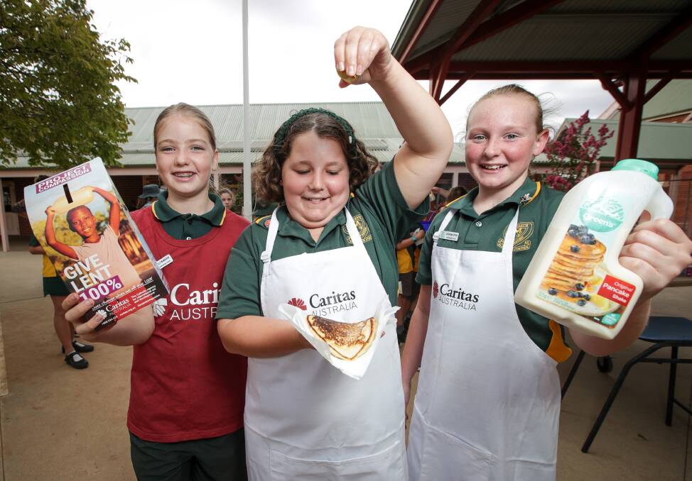FULL TOSS: St Mary's Primary School year 6 students Holly McMahon, Aleisha Price and Georgina Upton, all 11, help raise money for Caritas. Picture: JAMES WILTSHIRE