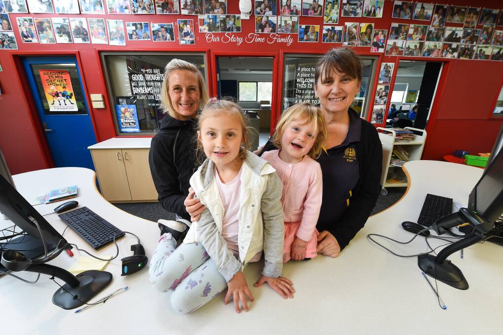 OPEN TO ALL: Melissa Petzke-Butler with her children Alanta, 5, and Azalea, 2, and St John's School Jindera library assistant Jodi Takle. Picture: MARK JESSER