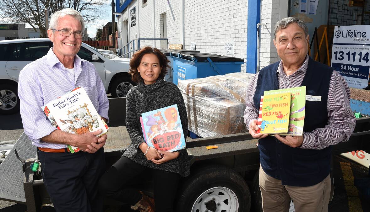 PLEASING RESPONSE: Donations to Books For Kids Global are collated by Rotary Club of Wodonga West's Jos Weemaes, Suthatta Kanprom and Lifeline Albury Wodonga chief executive Matt Burke. Picture: MARK JESSER