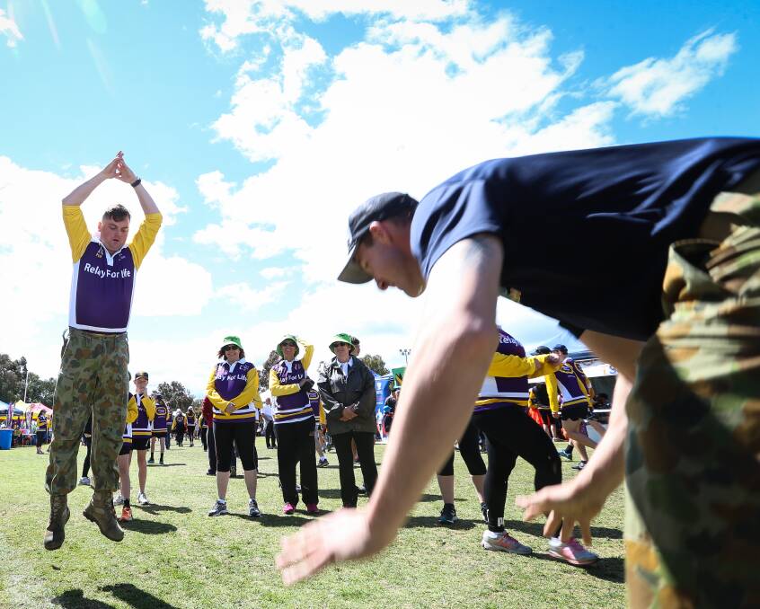 BURPEES FOR HIRE: Craftsman Stephen Kennedy and Private Mitch Moorhouse, of the ACW team, complete their exercises in return for a donation during the Border Relay for Life on Saturday morning. Pictures: JAMES WILTSHIRE