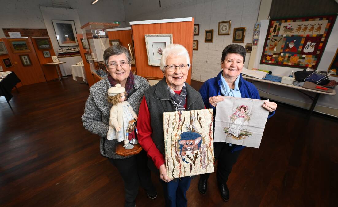 SEWING SHOWCASE: Art of the Cloth, which opens on Saturday at Chiltern Goods Shed, will display and demonstrate a variety of material-based crafts, including items held here by participants Margaret Grigsby, Betty Bjorksten and Judy Hunt. Picture: MARK JESSER