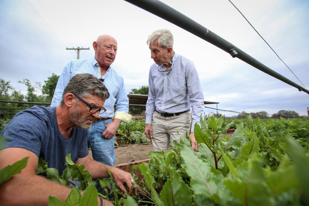 PLANTING IDEAS: Hume Murray Food Bowl past president Anthony Keck, president John Hennessy and secretary Michael O'Callaghan talk over plans for the farmers' market, which began in June 2002. Picture: JAMES WILTSHIRE