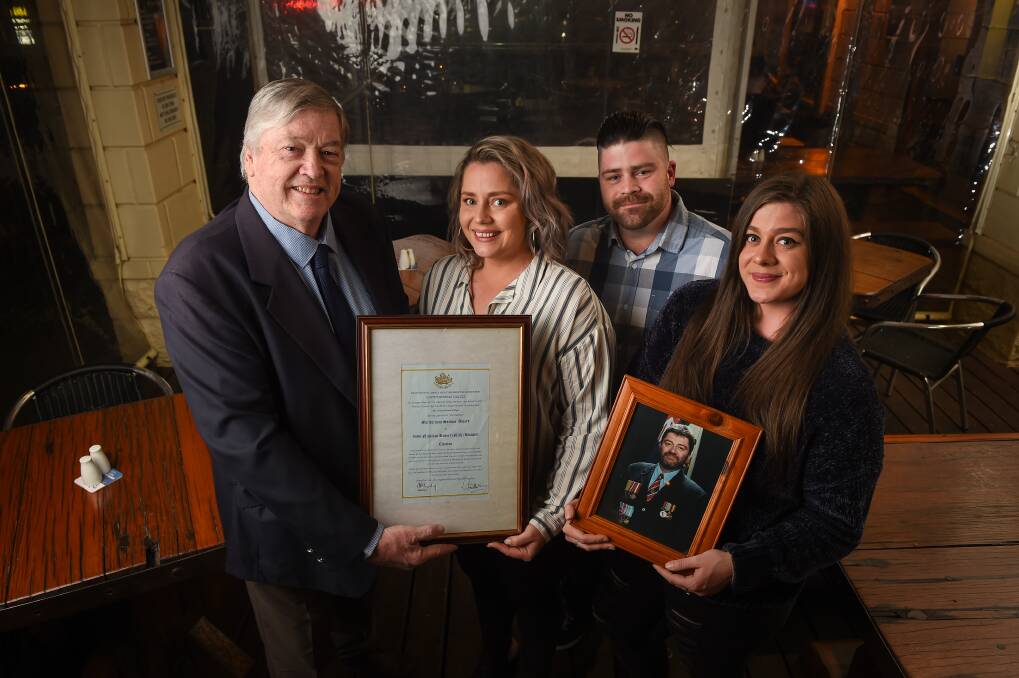 REMEMBERED: British South Africa Police Regimental Association Australian chairman Simon Johnstone presents the Meritorious Service Award to Nick Russell's children, Katie, Thomas and Kariba. Picture: MARK JESSER